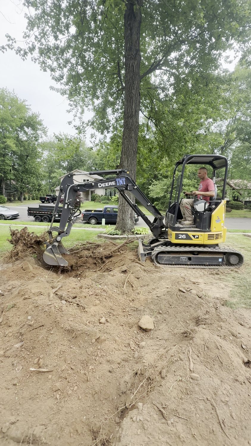 The owner-led TNT Masonry & Pavers crew excavating a job site in Connecticut with a mini excavator