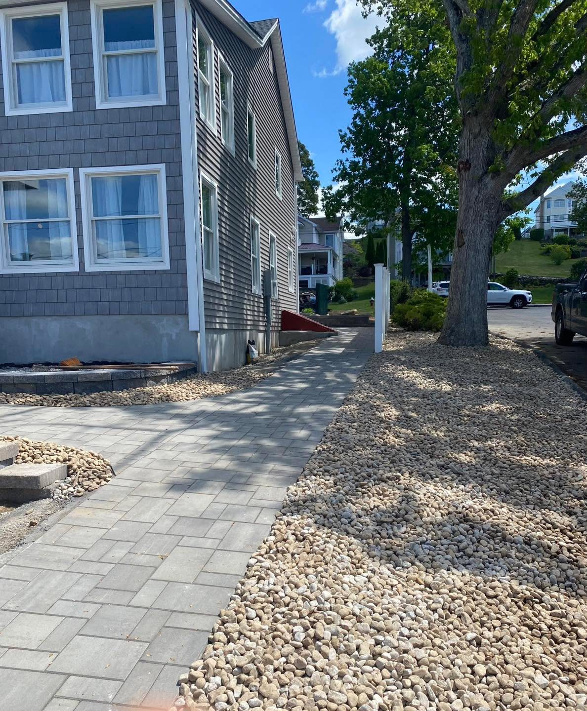 Walkway and River-Rock Beds by TNT Masonry & Pavers in Connecticut